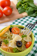Delicious pasta with tomatoes on plate on table close-up