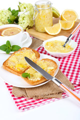 Delicious toasts with lemon jam on plate on table close-up