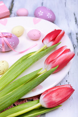 Easter table setting with tulips and eggs