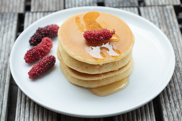 Stack of delicious pancakes with fresh fruits