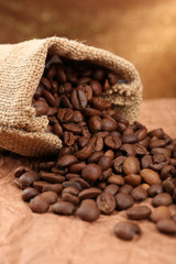 Coffee beans in sack on table close-up