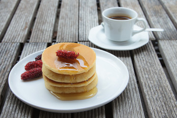Stack of delicious pancakes with fresh fruits
