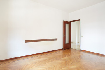 Empty room with wooden floor in normal apartment
