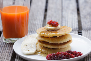 Stack of delicious pancakes with fresh fruits