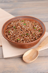 Boiled buckwheat in bowl on table close-up