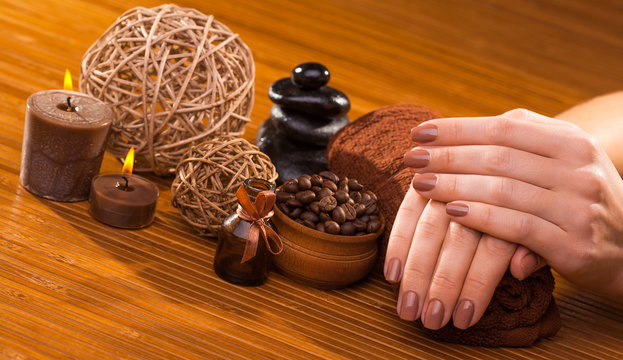 brown manicure on a bamboo background