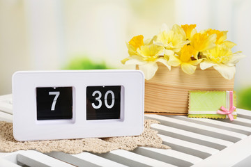 Alarm clock on table, on light background