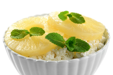 Bowl of tasty cottage cheese with pineapple, isolated on white