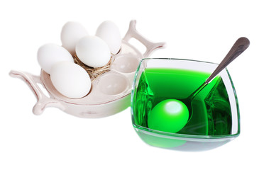 Fototapeta na wymiar Eggs with liquid colour in glass bowl isolated on white