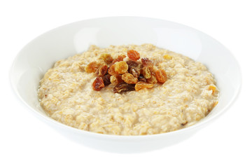 Tasty oatmeal with raisins isolated on white