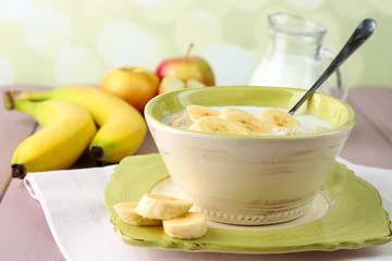 Tasty oatmeal with bananas and milk