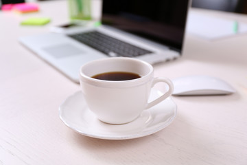 Fototapeta na wymiar Cup of coffee at workplace