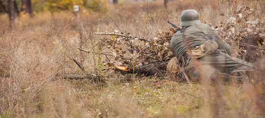 WWII German Soldier ready for shooting with a rifle