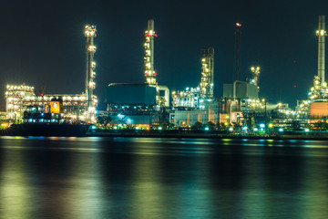 Fototapeta na wymiar Oil refinery at night with shadow in river