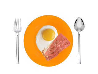 Scrambled eggs and roasted bacon with spices on orange plate wit