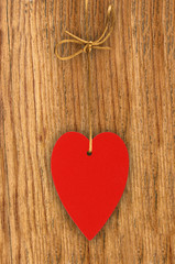 Love heart hanging on wooden texture background, valentines day