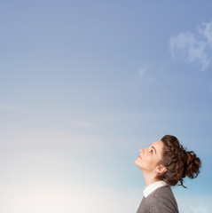 Girl looking at the blue sky copyspace