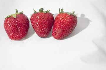 Three strawberries on a white background