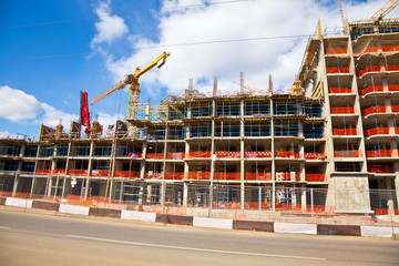 construction of buildings, yellow construction crane