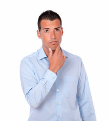 Pensive hispanic young man looking up