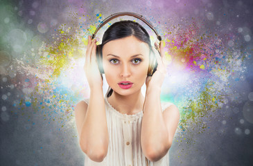 Beautiful girl listening to the music with a pair of headphones