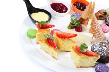 Plate of different desserts isolated