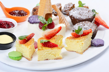 Plate of different desserts isolated