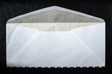 Open envelope on black background