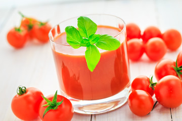 Fresh tomato juice wooden background
