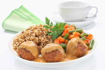 Pork meatballs with sauce, buckwheat, green beans and carrots