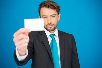 handsome businessman showing blank business card