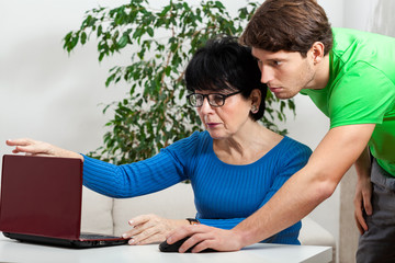 Elderly woman learning computer science