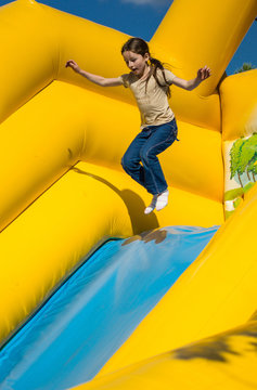 Young girl jumping on attractions