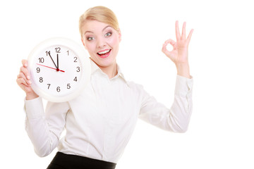 Portrait businesswoman showing clock and ok hand sign. Time.