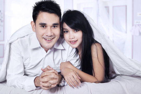 Portrait of asian couple on bed