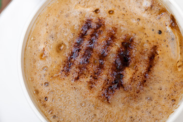 White cup coffe hot beverage drink with froth background texture