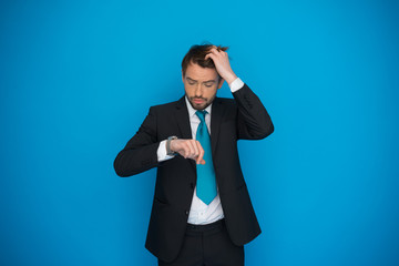 businessman in rush looking at his watch , running late