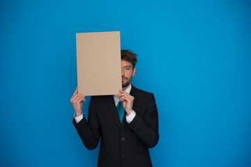 Businessman holding blank poster