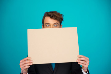 Businessman holding blank poster