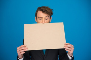 Businessman holding blank poster