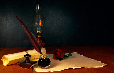 Feather pen with ink, scroll and kerosene lamp - 63513492