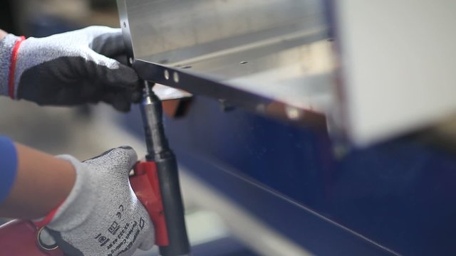 hands of worker in the factory rivet