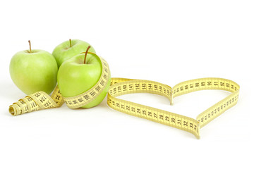 green apple with a measuring tape and heart symbol isolated