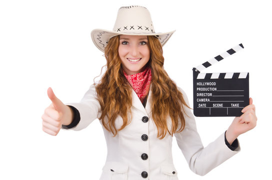 Young   thumbing  cowgirl  with movie board isolated on white