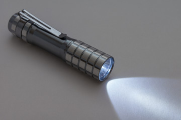 Shining a flashlight on a grey background