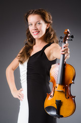 Woman artist with violin in music concept