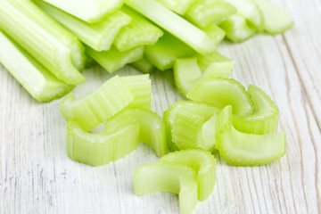 cut celery on wooden table © Diana Taliun
