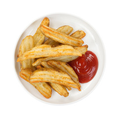 Baked potato wedges in dish with ketchup