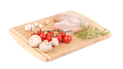 Raw chicken breast and vegetables