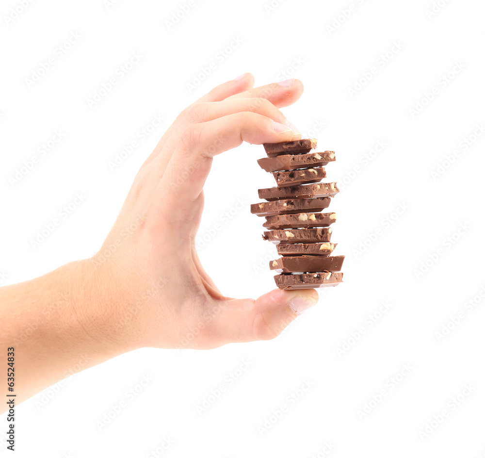 Wall mural hand holds milk chocolate with nuts.